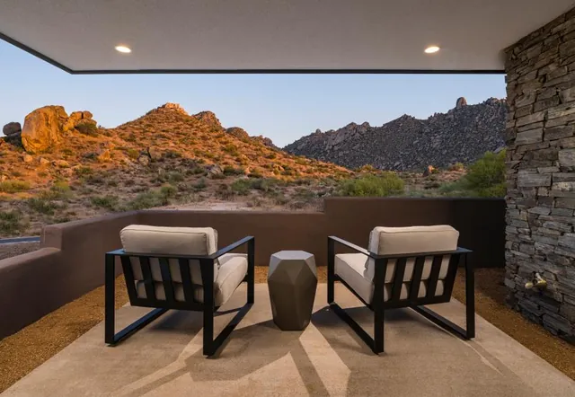 Terrace chairs facing the boulders at sunset