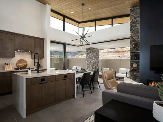 Kitchen island with the fireplace and dining area beyond