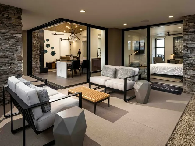 Covered terrace with lounge chairs, open to the great room and bedroom