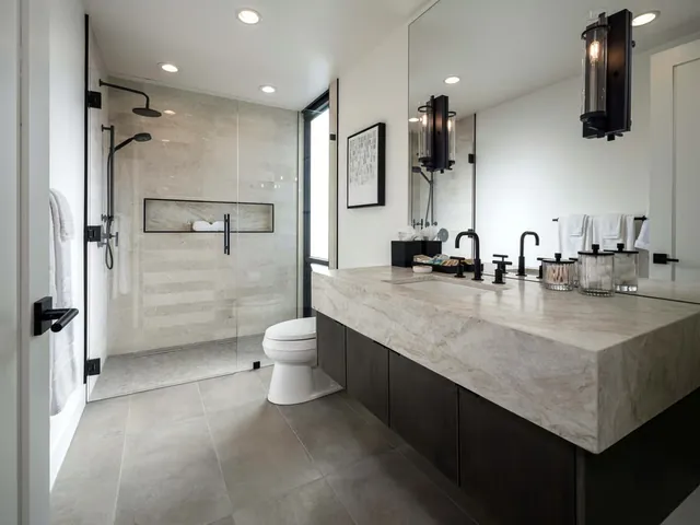 Suite bathroom with a stone vanity and a walk-in shower