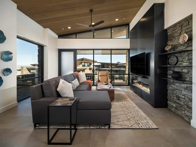Living area with a steel fireplace wall and stone shelves