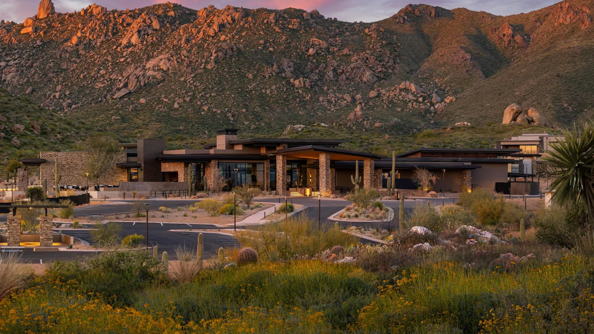 Mountain House Lodge at dusk, below the boulders and peaks of the McDowell Mountains